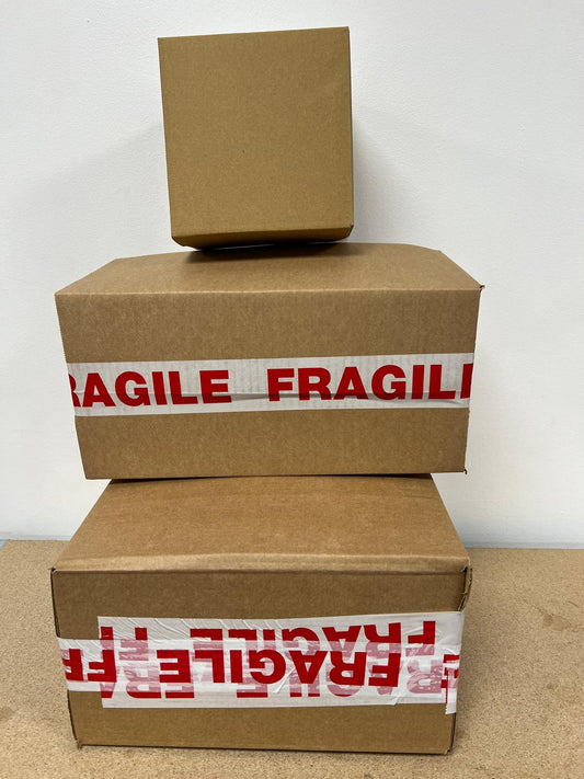 Stack of 3 cardboard boxes containing gift orders, ready to post out. Labelled fragile