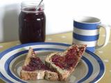 jar of plum marrow and fennel jam spread on slice of bread